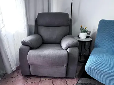 a gray chair sitting in a room with a table at Casa Girasol PZ in San Isidro