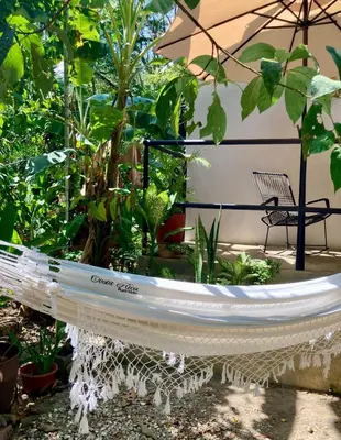 a white boat in a garden with plants at Ital Mountain modern hideaway with tropical vibes in Mal País