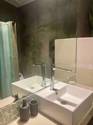 a bathroom with a white sink and a mirror at Ital Mountain modern hideaway with tropical vibes in Mal País