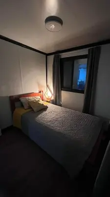 a bedroom with a large bed with a window at Casa Loma del Lago - Lake Arenal View in Tilarán