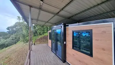 a covered porch of a house with a view at Casa Loma del Lago - Lake Arenal View in Tilarán
