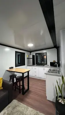 a kitchen with a table and a sink and a couch at Casa Loma del Lago - Lake Arenal View in Tilarán