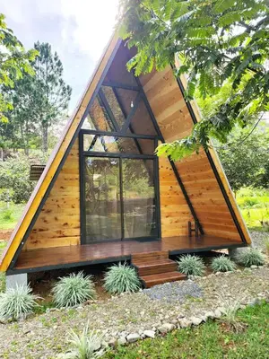 a tiny house with a large window at Glamping Moku