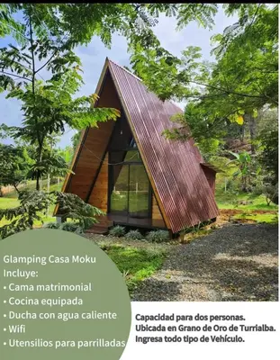 a small house with a metal roof at Glamping Moku