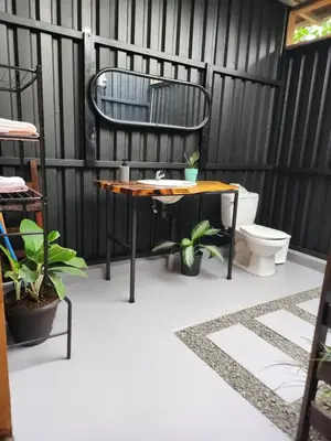 a patio with a table and a chair and a toilet at Glamping Moku