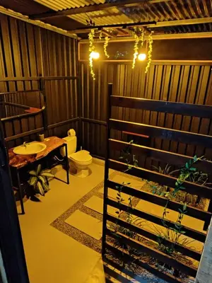 a bathroom with a toilet and a sink at Glamping Moku