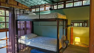 a bedroom with two bunk beds in a house at Hostal con camas compartidas - Pachamama Bio in Tamarindo