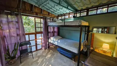 a bedroom with two bunk beds in a house at Hostal con camas compartidas - Pachamama Bio in Tamarindo