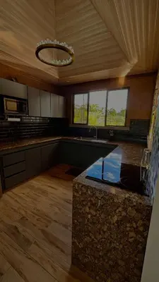 a large kitchen with a counter top in a room at Arenal Stone House in Ángeles