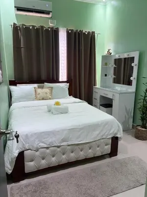 a bedroom with a large white bed and a desk at House equipped with a Jacuzzi in Quepos in Quepos