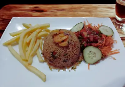 a plate of food with a burger and french fries at Naranjo Easy Lodge in Paquera