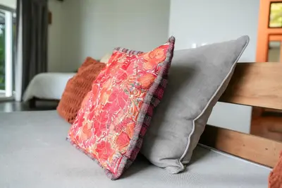 two pillows are sitting on a couch at Beachfront Bliss Steps to the beach in Playa Azul