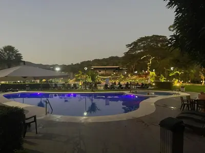 a swimming pool at night with purple lights in it at Casa Duna in Herradura