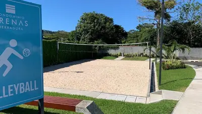 a volleyball court in a park with a sign at Casa Duna in Herradura