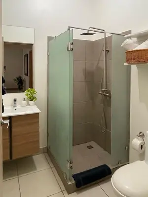 a bathroom with a shower with a toilet and a sink at Casa Duna in Herradura