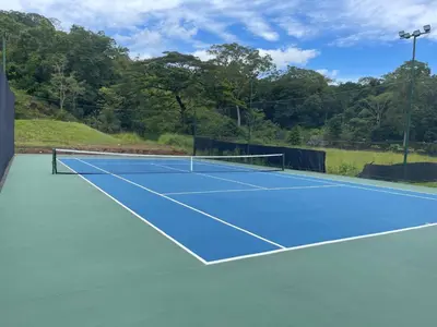a tennis court with a net on it at Casa Duna in Herradura