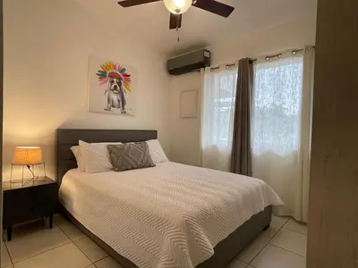 a bedroom with a bed and a ceiling fan at Casa Duna in Herradura