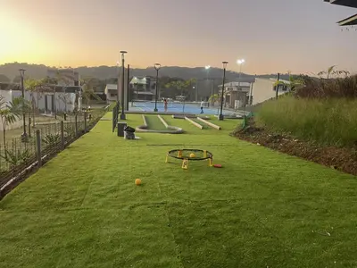 a playground with a trampoline on the grass at Casa Duna in Herradura