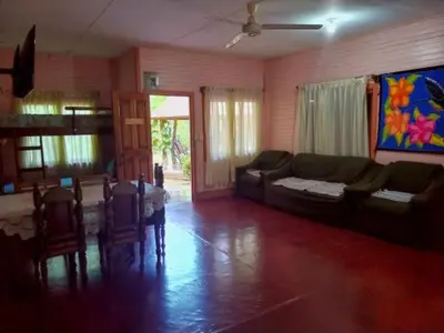 a living room with a couch and a table and chairs at Corozalito Turtle Lodge in Corozalito