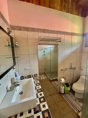 a bathroom with a sink and a shower and a toilet at Manys house in Ballena
