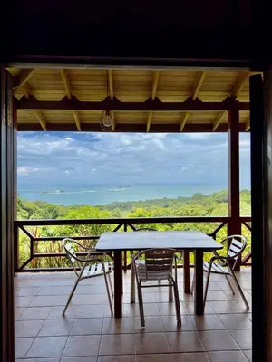 a table and chairs on a balcony with a view at Manys house in Ballena
