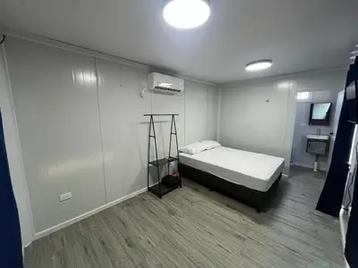 a small room with a bed and a bathroom at Cabinas Pacific Breeze in Parrita