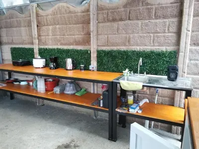a table with a sink next to a brick wall at Cabinas Pacific Breeze in Parrita