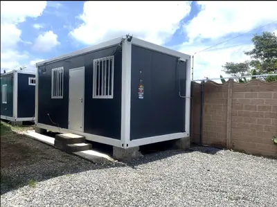a large blue container sitting next to a fence at Cabinas Pacific Breeze in Parrita