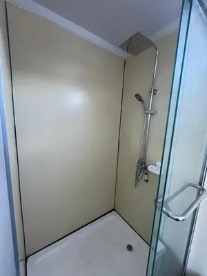 a shower with a glass door in a bathroom at Cabinas Pacific Breeze in Parrita
