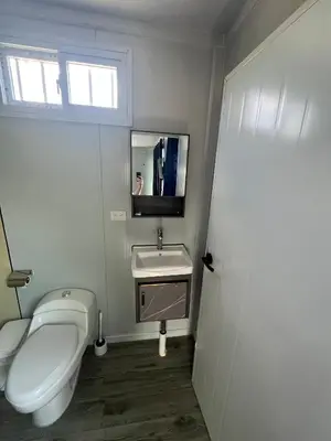 a bathroom with a toilet and a sink at Cabinas Pacific Breeze in Parrita