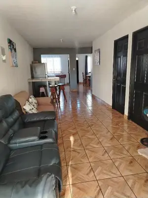 a living room with a couch and a table at Casa Vacacional Brisas del Volcán Miravalles in Hacienda Guayabo
