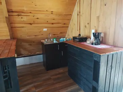 a kitchen with a counter and a sink in a cabin at Mount & Wood in San Marcos