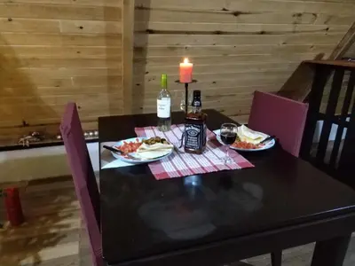 a black table with two plates of food and a candle at Mount & Wood in San Marcos