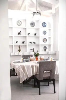a dining room with a table and plates on the wall at Green villa in La Asunción