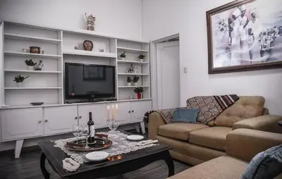 a living room with a couch and a tv at Green villa in La Asunción