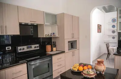 a kitchen with a bowl of fruit on a table at Green villa in La Asunción