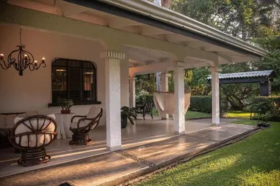 a porch of a house with chairs and a chandelier at Green villa in La Asunción