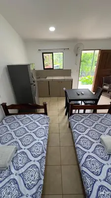 a room with two beds and a table in it at Casa Antioquia #5 in Garita