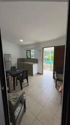 a kitchen and living room with a table and chairs at Casa Antioquia #5 in Garita