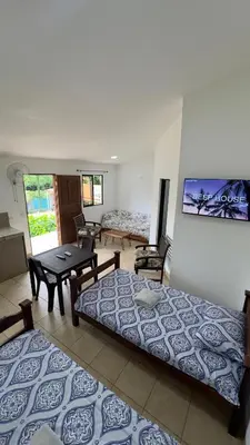 a living room with two beds and a table at Casa Antioquia #5 in Garita