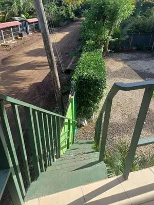 a stairway with a green railing next to a street at Casa Antioquia #5 in Garita