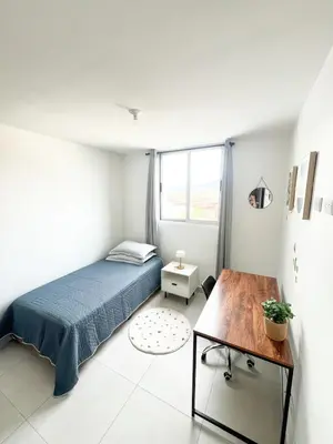 a bedroom with a bed and a table in it at Apartamento en San Pablo, Heredia, Costa Rica in San Pablo