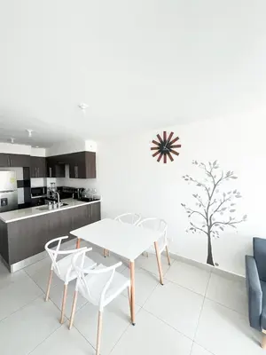 a kitchen with a table and chairs and a tree on the wall at Apartamento en San Pablo, Heredia, Costa Rica in San Pablo