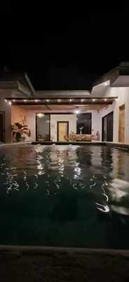 a swimming pool in a house at night at Casa Abana in Sámara
