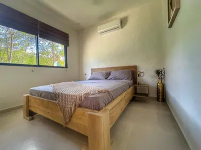 a bedroom with a bed in a room with a window at Casa Abana in Sámara