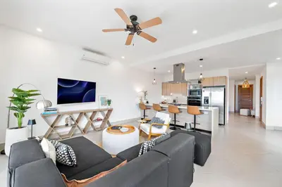a living room with a couch and a ceiling fan at Stunning Oceanview 3BR Condo Walk to Tamarindo in Tamarindo
