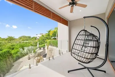 a room with a bird cage hanging from the ceiling at Stunning Oceanview 3BR Condo Walk to Tamarindo in Tamarindo