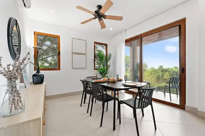 a dining room with a table and chairs and a ceiling fan at Stunning Oceanview 3BR Condo Walk to Tamarindo in Tamarindo