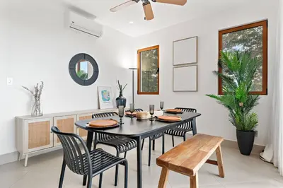 a dining room with a black table and chairs at Stunning Oceanview 3BR Condo Walk to Tamarindo in Tamarindo