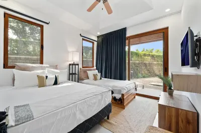 a bedroom with two beds and a large window at Stunning Oceanview 3BR Condo Walk to Tamarindo in Tamarindo